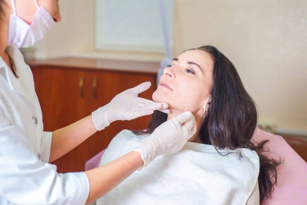 Female patient consulting with medical professional before cosmetic procedure to ensure safe filler treatment.