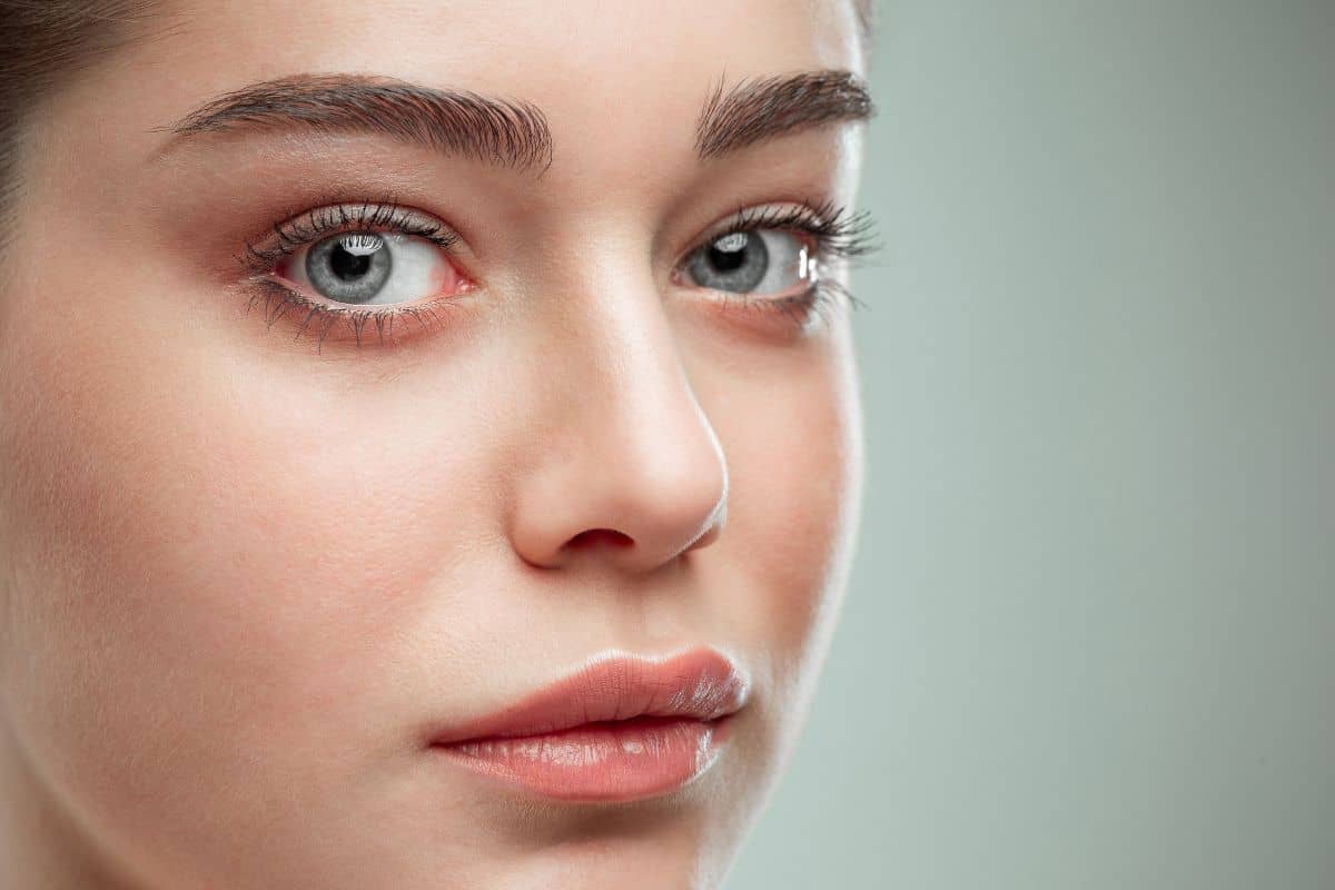Close-up of a woman's nose and lips symbolizing rhinoplasty with financing support from The Naderi Center.