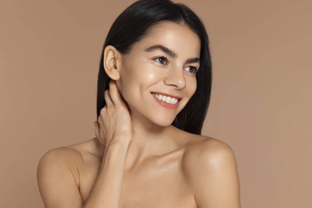 Woman with glowing, even skin tone smiling confidently after gentle, non-thermal 3D Miracle Laser skin treatment.