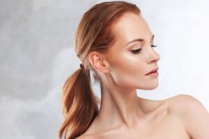 Woman with youthful skin showing smooth neck profile after neck rejuvenation treatment.