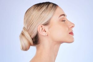 Side view of woman with smooth skin and balanced nose, reflecting rhinoplasty results and cost considerations.