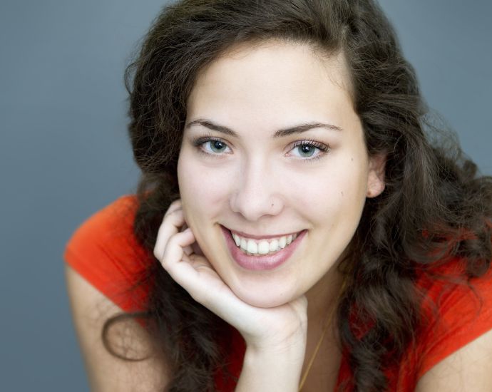 Smiling woman with distinct nasal features representing natural beauty and ethnic identity related to Jewish heritage.