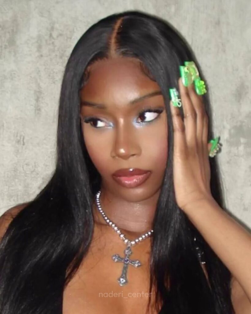 Black woman with sleek hair and defined nose, representing structural grafting techniques used in African rhinoplasty.