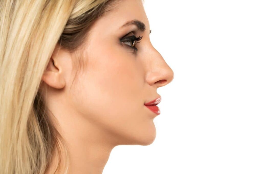 Side profile of woman showing nasal structure, emphasizing risks of poorly performed rhinoplasty and revision need.