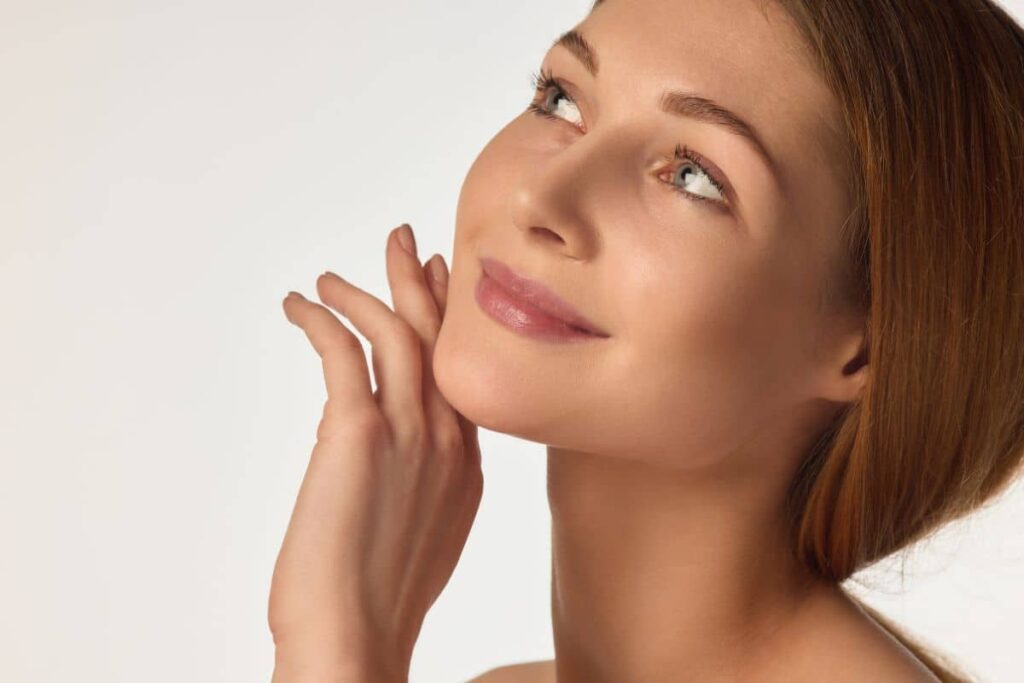Woman with defined facial contours showing sculpted cheeks, smooth jawline, and symmetrical chin