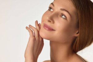 Woman with defined facial contours showing sculpted cheeks, smooth jawline, and symmetrical chin