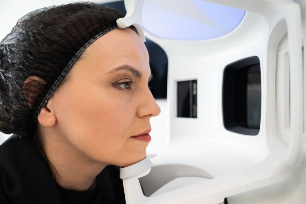Woman undergoing VISIA Skin Analysis for personalized treatment planning using advanced facial imaging technology.