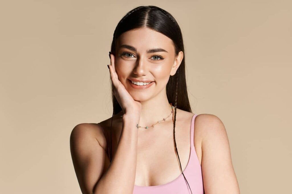 Smiling woman with symmetrical features showcasing natural-looking result. 