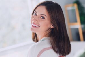 Woman with refreshed, smooth complexion smiling confidently after receiving subtle and natural Botox treatment.