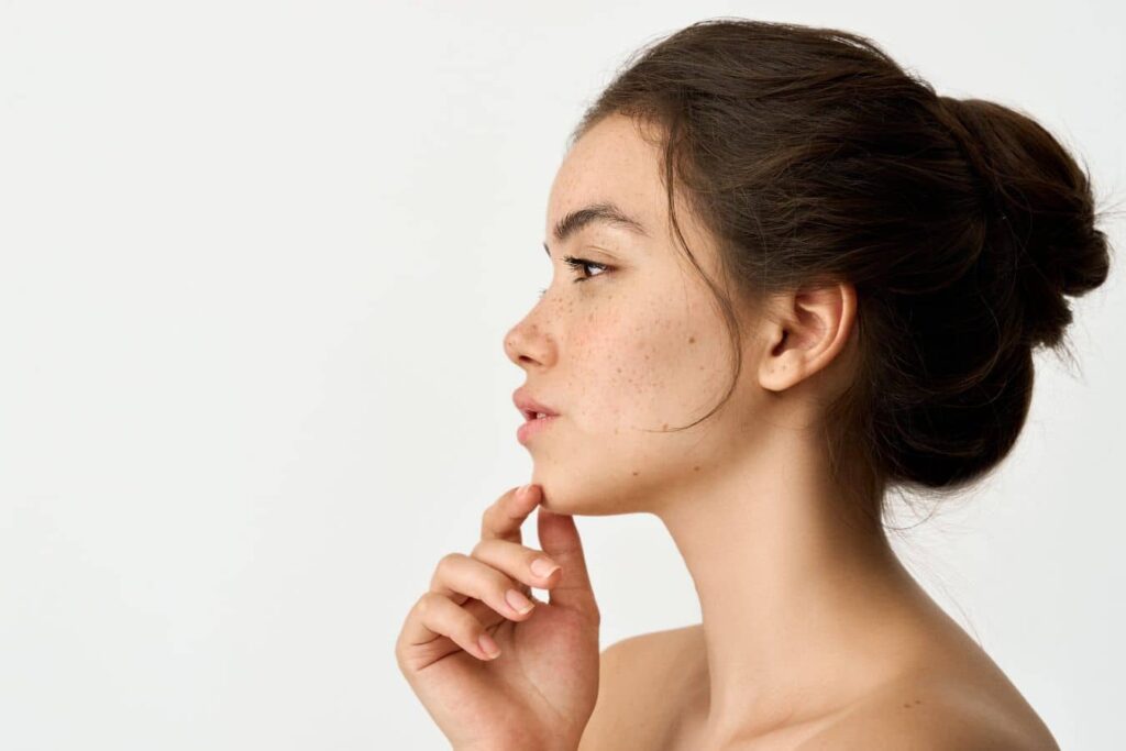 Woman in side profile highlighting chin projection and facial balance, representing chin augmentation and implant surgery results