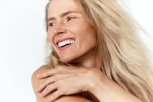 Smiling mature woman with smooth, radiant skin, representing UltraClear® Laser recovery and improved skin tone and texture.