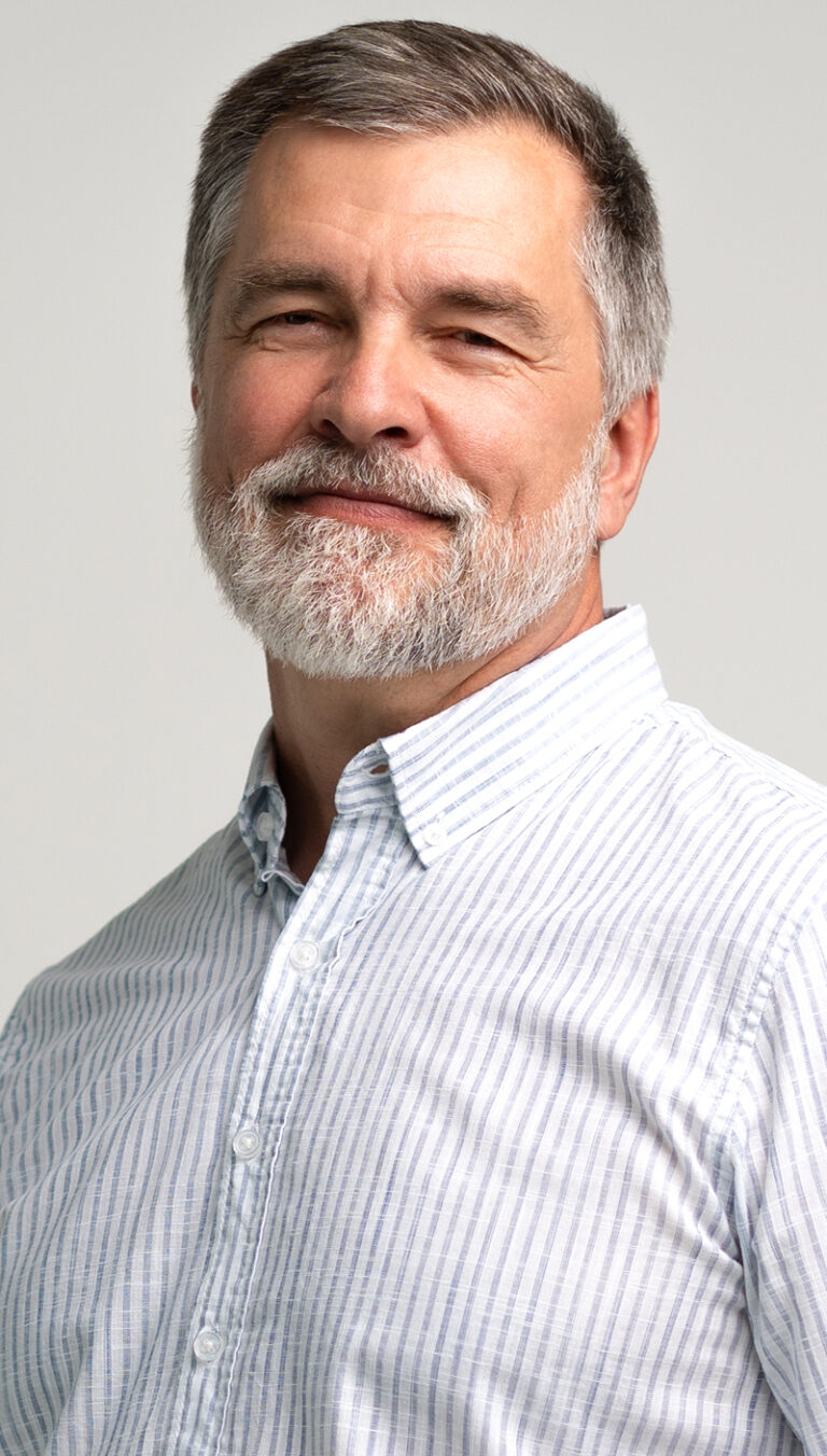 Confident older man with a grey beard, representing men considering a deep plane facelift