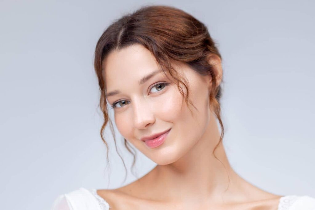 Young woman with soft features and minimal makeup representing a balanced look and natural aesthetic refinement