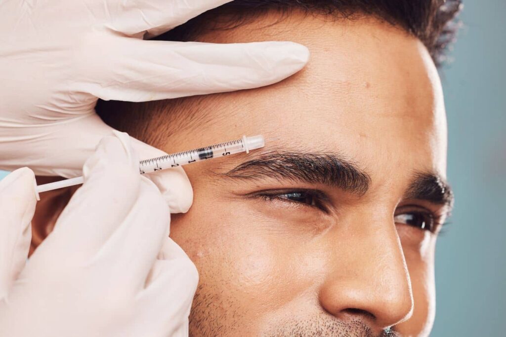 Practitioner administering Daxxify injection to forehead, highlighting precision technique and longer-lasting neuromodulator treatment