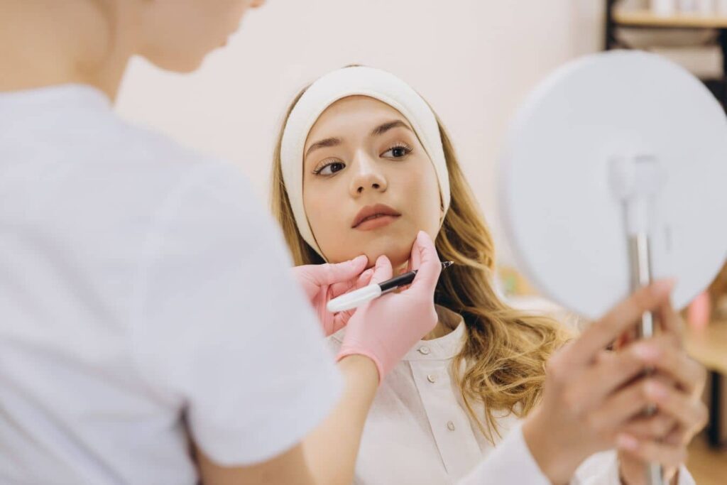 Patient consulting aesthetic provider, reflecting subtle enhancement and natural enhancement with balanced undetectable results