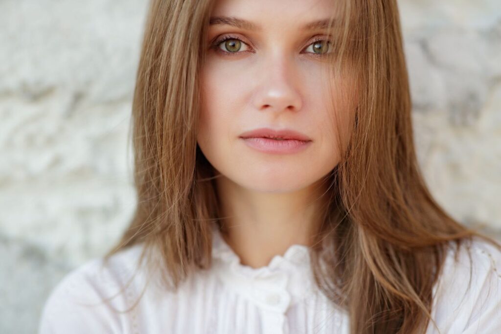 Woman with clear skin and bright eyes illustrating natural blepharoplasty results and youthful eye rejuvenation