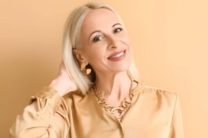 Smiling mature woman representing natural celebrity facelift results and modern facial rejuvenation aesthetics