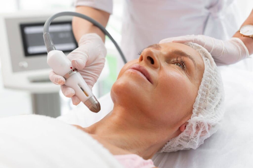 Patient receiving non-surgical facial rejuvenation treatment to improve skin texture, collagen, and youthful appearance