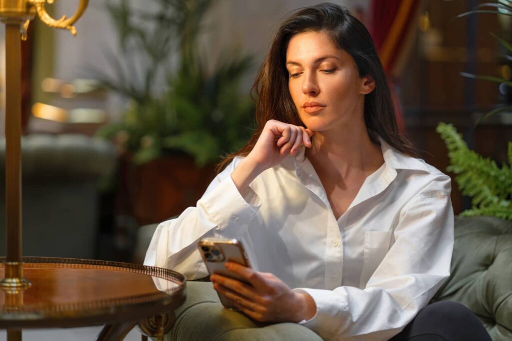 Woman researching deep plane facelift options online, reflecting growing demand for natural facelift results and surgeon expertise.