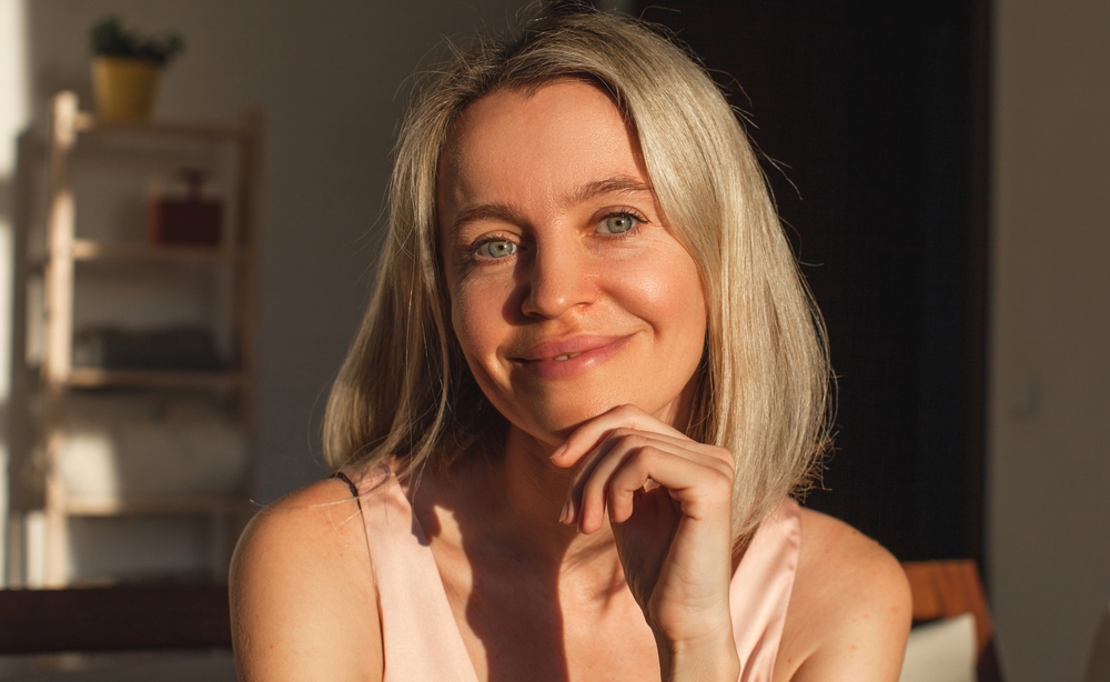 Woman with youthful facial contours illustrating facial bone loss reversal options through modern facial rejuvenation treatments.