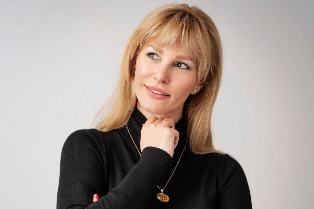 Woman thoughtfully looking aside, illustrating questions about mini facelift expectations and facial rejuvenation options.
