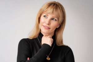 Woman thoughtfully looking aside, illustrating questions about mini facelift expectations and facial rejuvenation options.