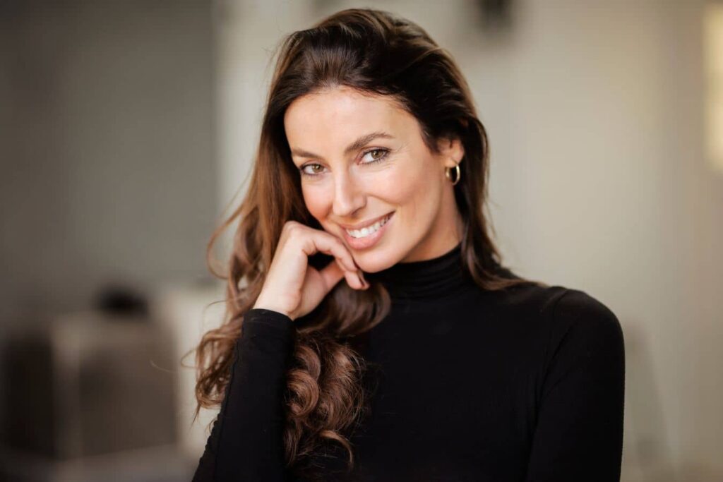 Confident professional woman representing modern facelift patients seeking natural facial rejuvenation and facial harmony.
