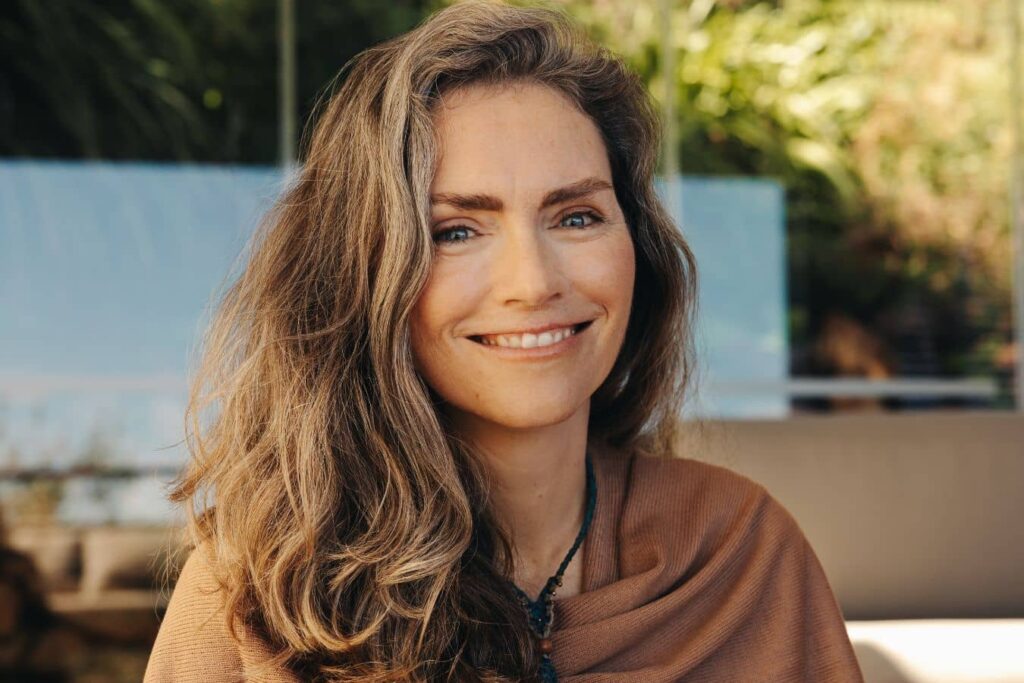 Confident woman with youthful facial contours, representing discreet and natural-looking facelift rejuvenation.