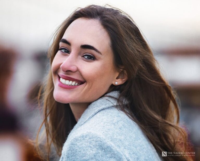 Smiling woman with smooth, clear skin, representing acne scar laser treatment at The Naderi Center in Reston and Chevy Chase